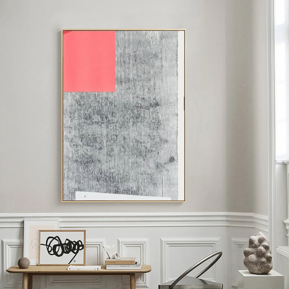 Room mockup. A coral-red rectangle occupies the upper left of a pale grey field covered with dark fine textured marks.