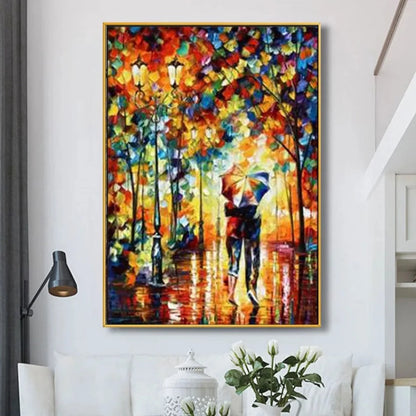 Room mockup showing couple under an umbrella on a wet park path beneath dense colourful autumn foliage and glowing lamps.