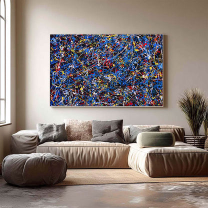 Abstract painting on a wall above a beige sofa in a living room.