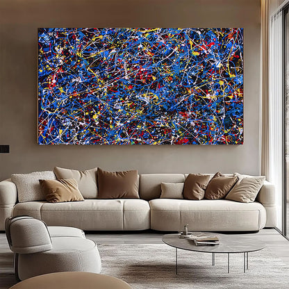 Modern living room with a large abstract painting on the wall above a beige sofa.