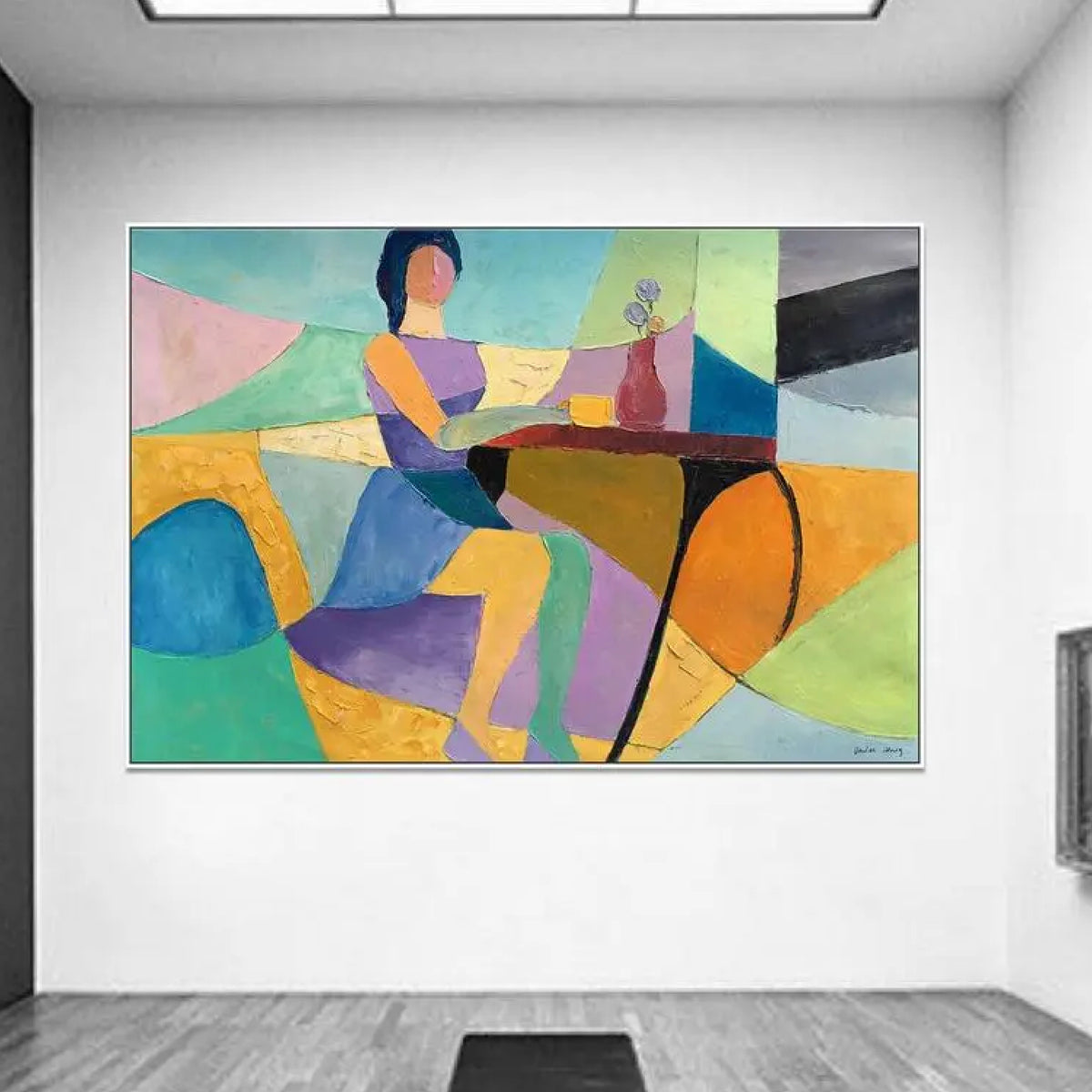 Room mockup. A stylised seated woman beside a table with a cup and flower vase, amid turquoise, yellow, orange and purple shapes.