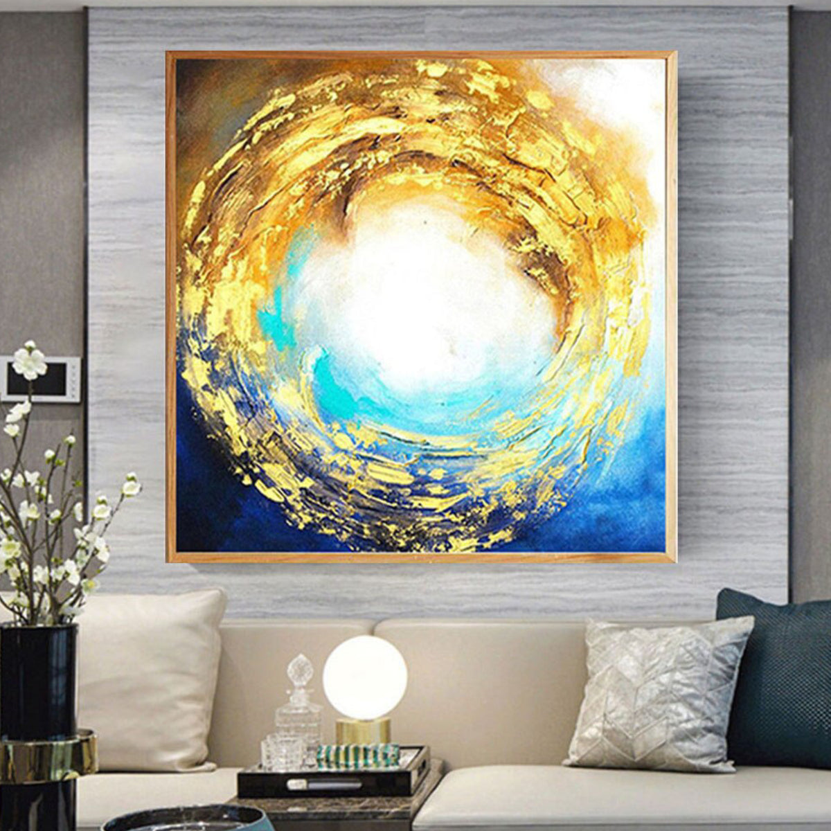Room mockup. Gold-coloured and ochre textured arcs spiral around a bright white centre above deep blue and turquoise.