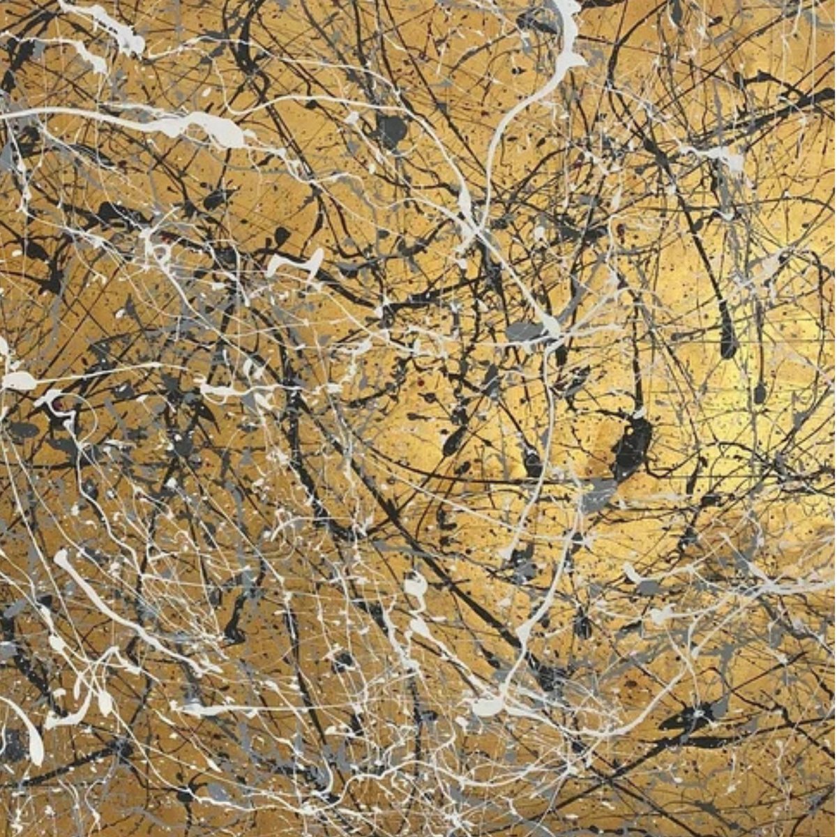 Detail of black, grey and white drip lines across a gold-toned ground.