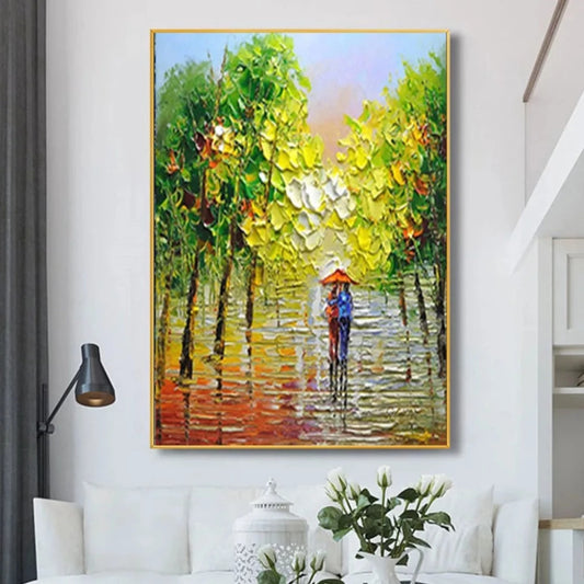 Room mockup showing small figure beneath a red umbrella walking along a wet path lined with bright green trees and warm reflections.