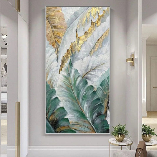 Room mockup showing large layered tropical leaves in pale green, white and grey with gold-coloured accents.
