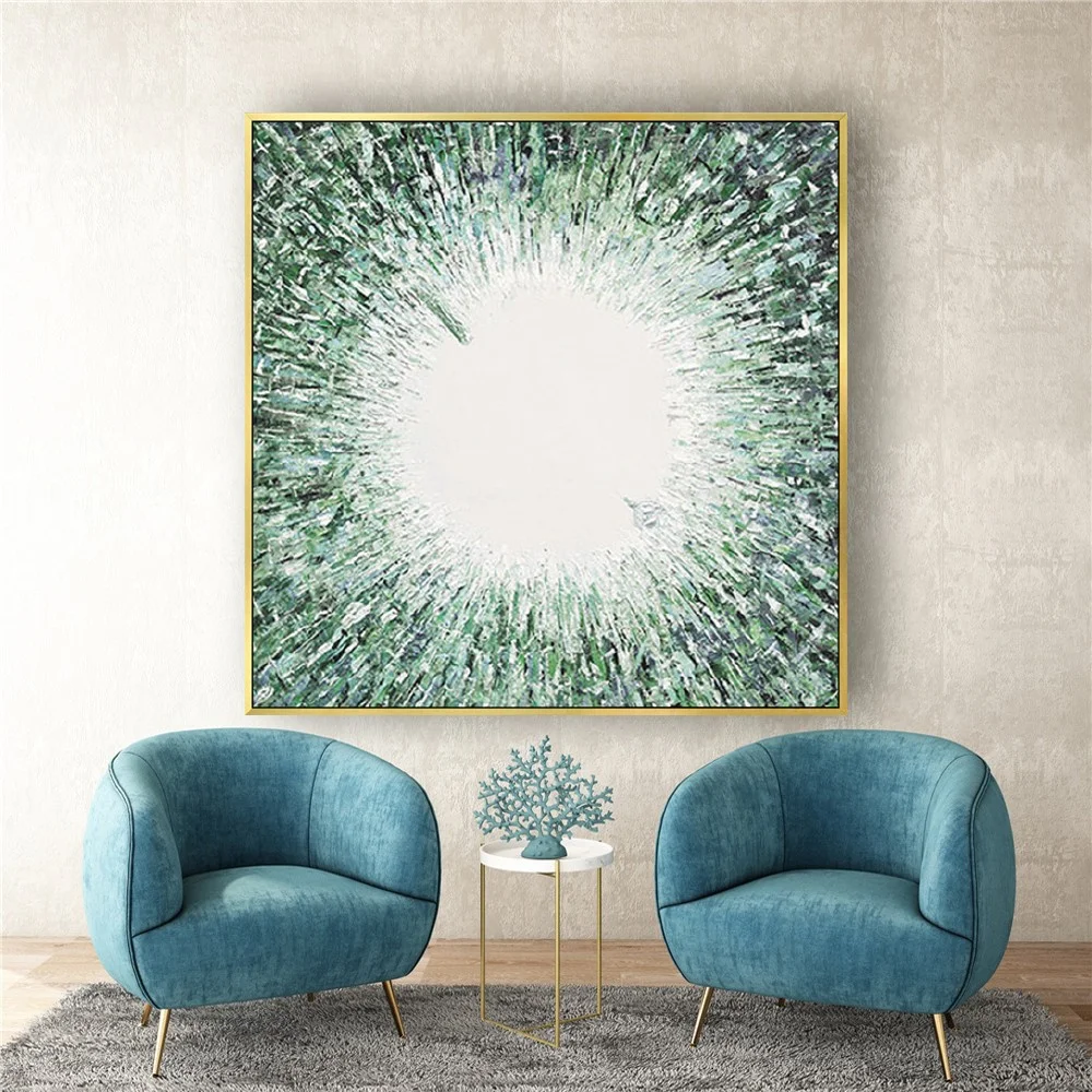 Room mockup showing green and white abstract painting with dense textured marks radiating around a bright white centre.