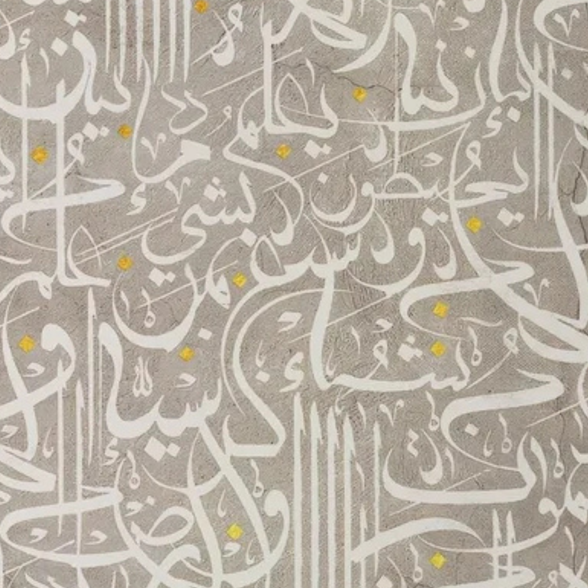 Detail of flowing white script and small gold accents across a textured grey ground.
