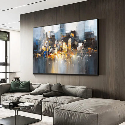 Room mockup showing abstract city-like blocks in grey, blue, black and gold-coloured tones reflected across a pale lower area.