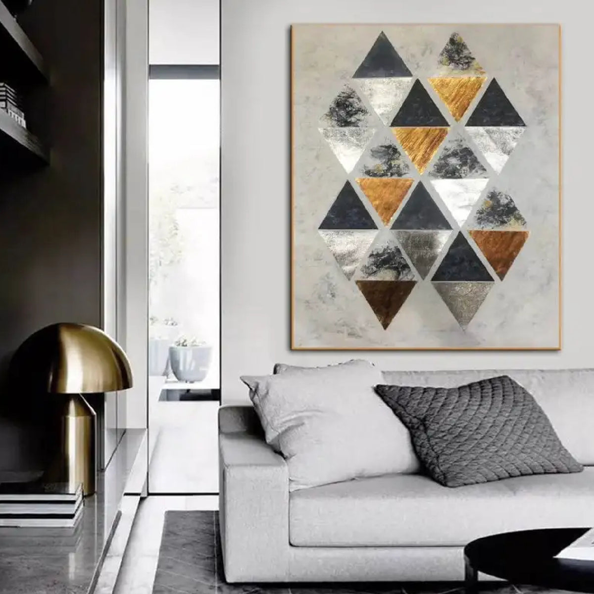 Room mockup. A staggered cluster of black, grey, white and ochre triangles on a pale cream textured ground.