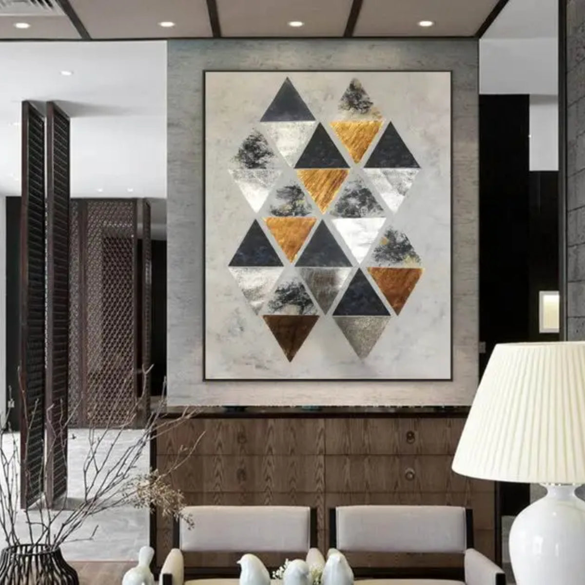 Room mockup. A staggered cluster of black, grey, white and ochre triangles on a pale cream textured ground.