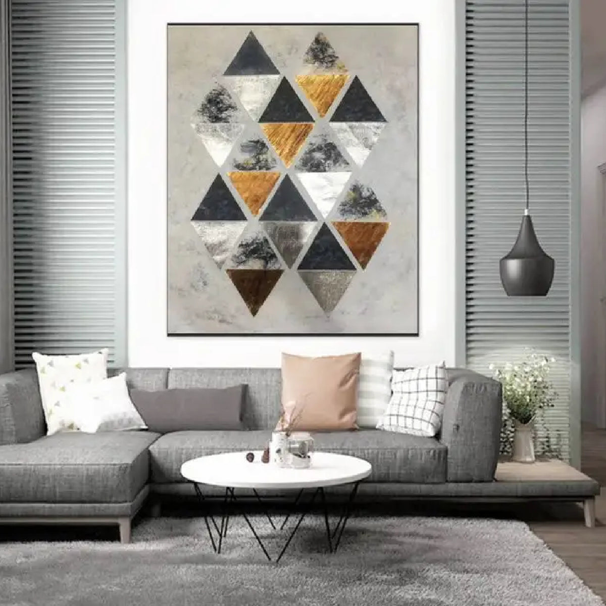 Room mockup. A staggered cluster of black, grey, white and ochre triangles on a pale cream textured ground.