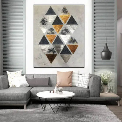 Room mockup. A staggered cluster of black, grey, white and ochre triangles on a pale cream textured ground.