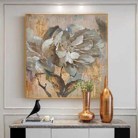 Room mockup. A layered grey and white flower with dark leaves against textured beige and ochre patches.
