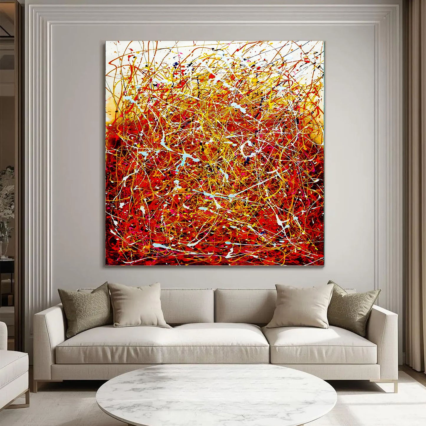 Abstract painting in a modern living room with a beige sofa and round coffee table.