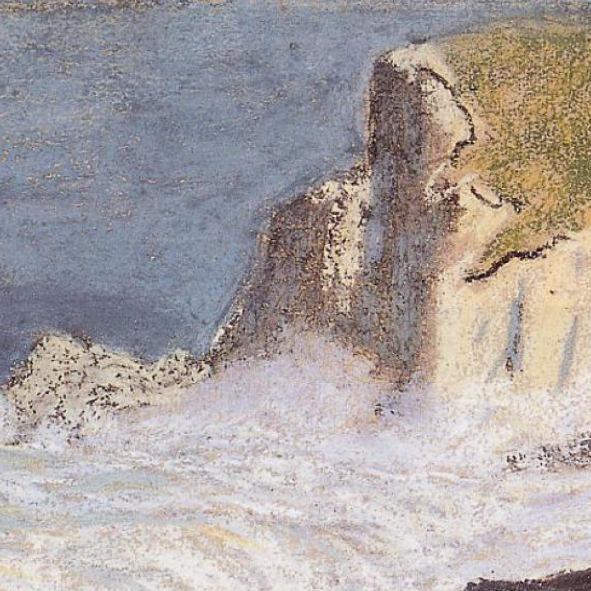 Close-up of white cliff faces above the foaming shoreline.