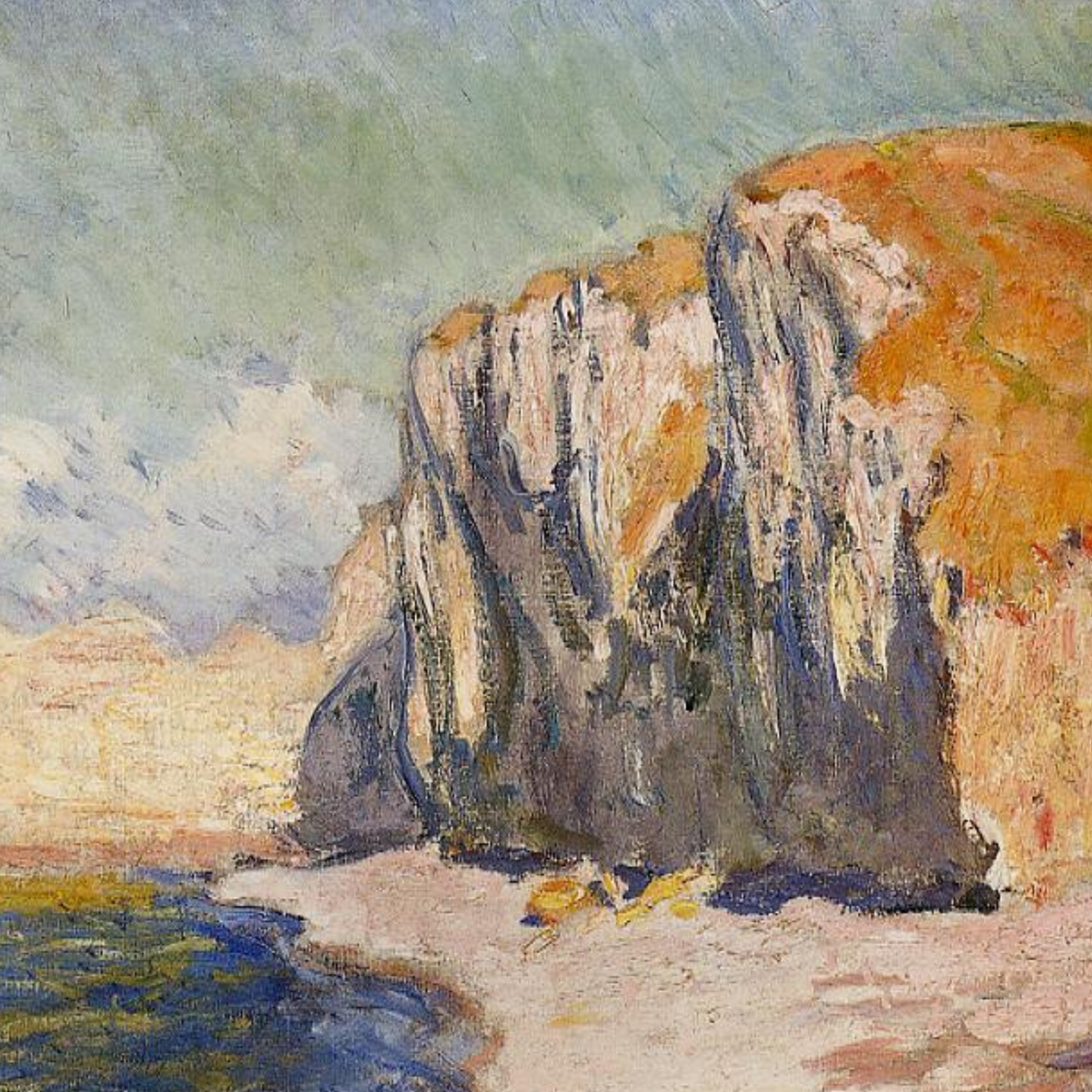 Close-up of white and ochre chalk cliffs above blue-green sea.