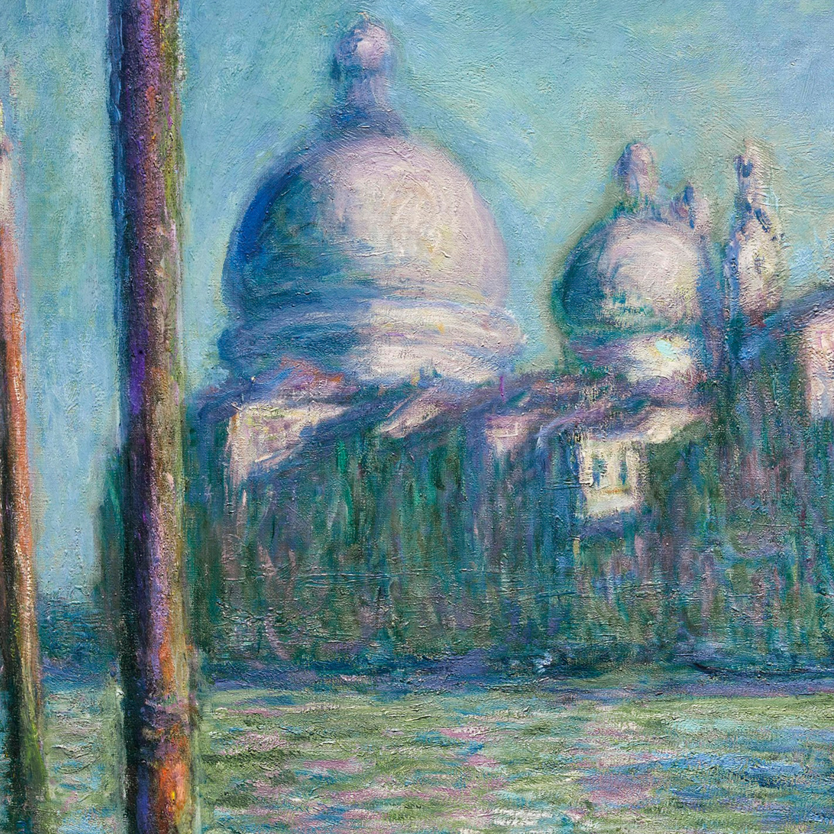 Close-up of pale domes, canal buildings and blue-green reflections.
