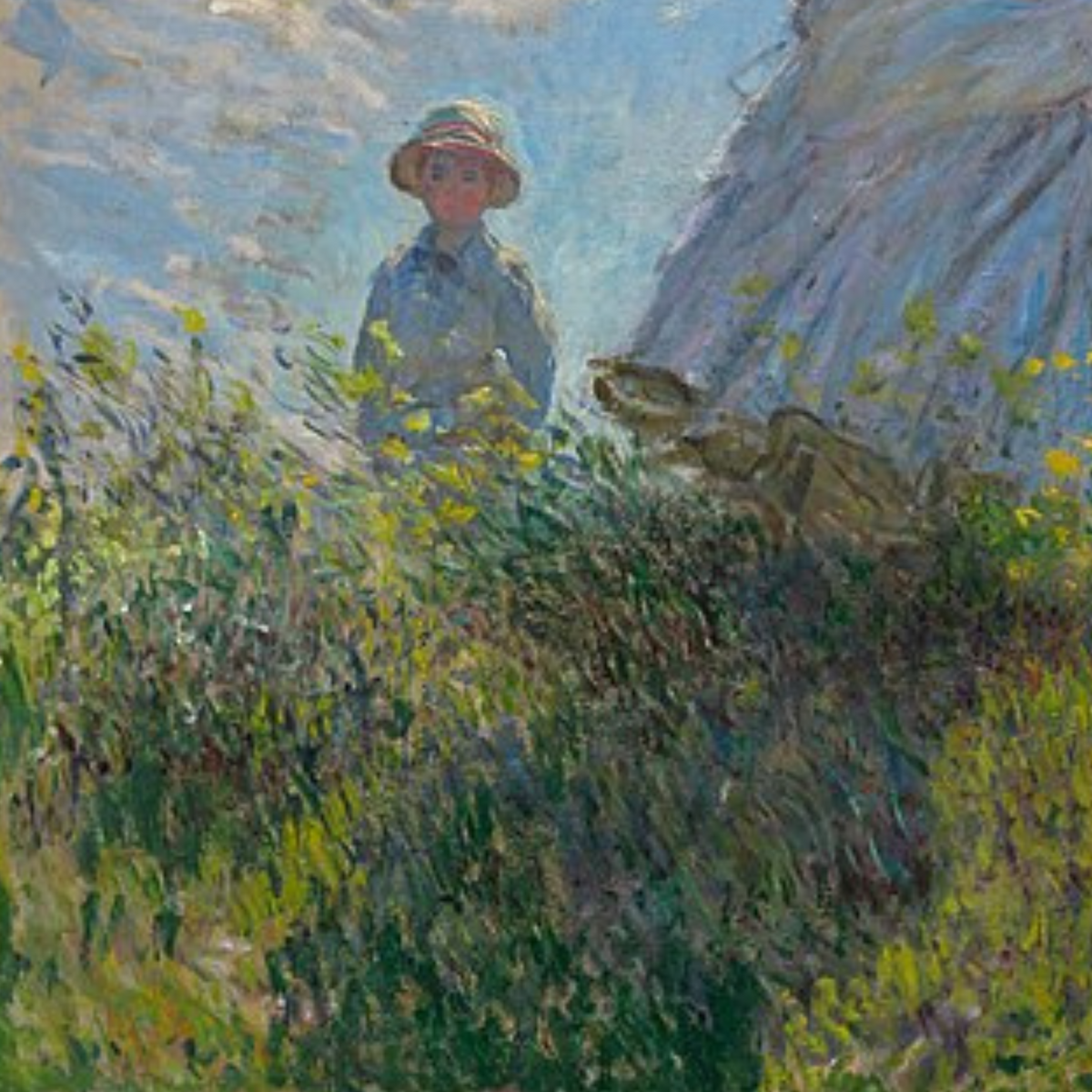 Detail of a child standing behind the grassy slope.