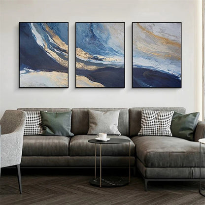 Room mockup showing three abstract panels with deep blue fields, pale blue and cream sweeping bands and gold-coloured accents.