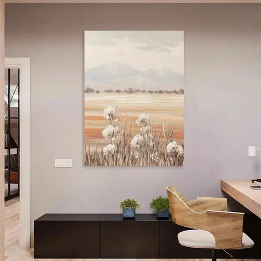 Room mockup showing white wildflowers above tan meadow bands with distant grey mountains beneath a pale clouded sky.