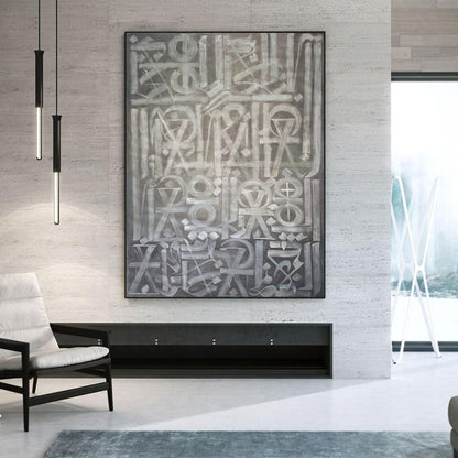 Hand-painted canvas showing symbols, calligraphic marks and geometric forms in neutral tones, displayed in a living room.