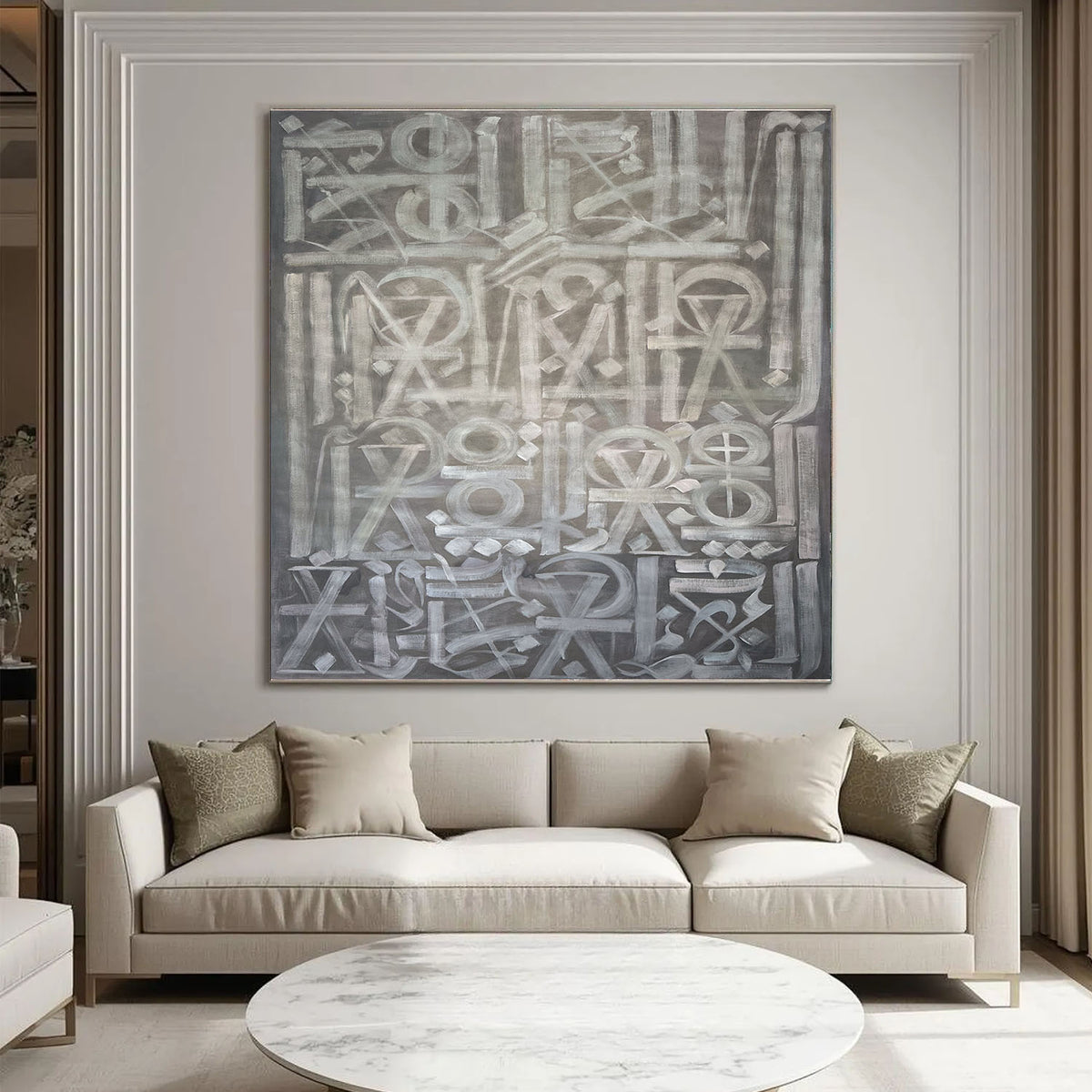 Hand-painted canvas showing symbols, calligraphic marks and geometric forms in neutral tones.