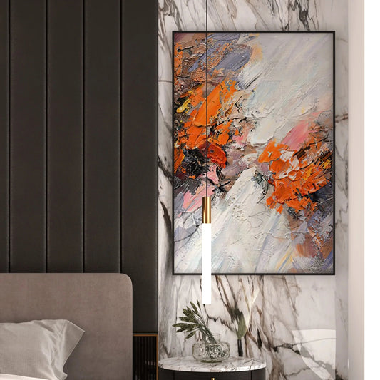 Room mockup showing thick diagonal white and grey strokes crossed by orange, pink and black textured patches.