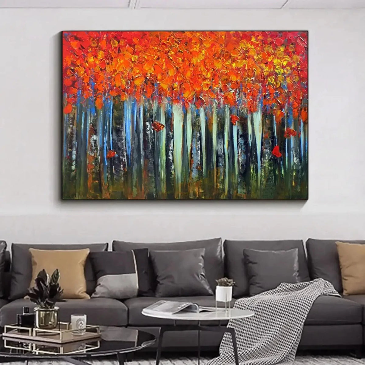 Room mockup showing dense orange and red autumn foliage above slender pale blue and dark tree trunks against a deep green forest floor.