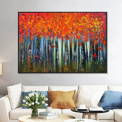 Room mockup showing dense orange and red autumn foliage above slender pale blue and dark tree trunks against a deep green forest floor.
