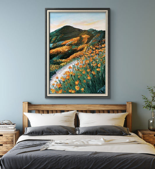 Room mockup showing orange wildflowers beside a winding pale path through dark green hills beneath a pastel sky.