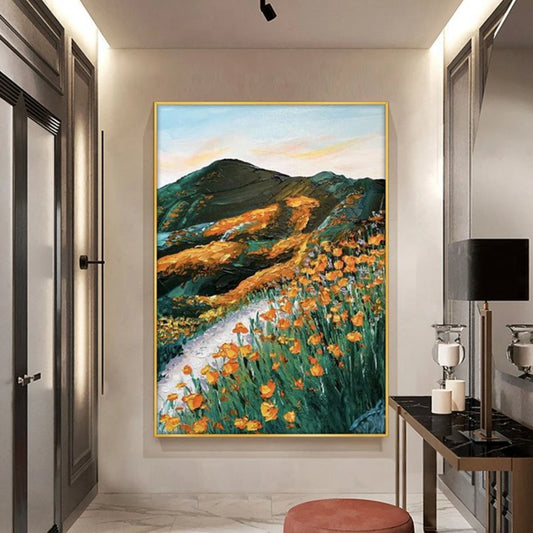 Room mockup showing orange wildflowers beside a winding pale path through dark green hills beneath a pastel sky.