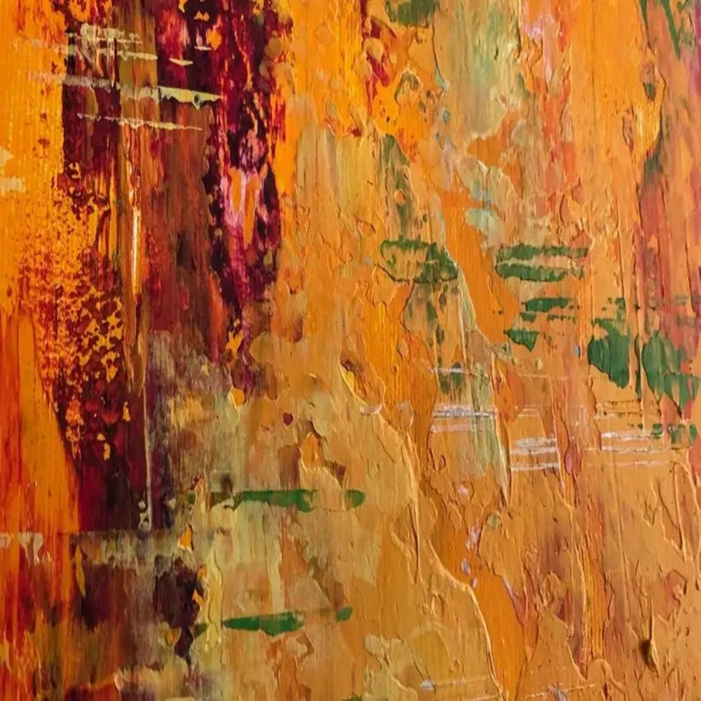 Close-up of bright orange and yellow textured field with dark red patches, small green marks and loose vertical strokes.