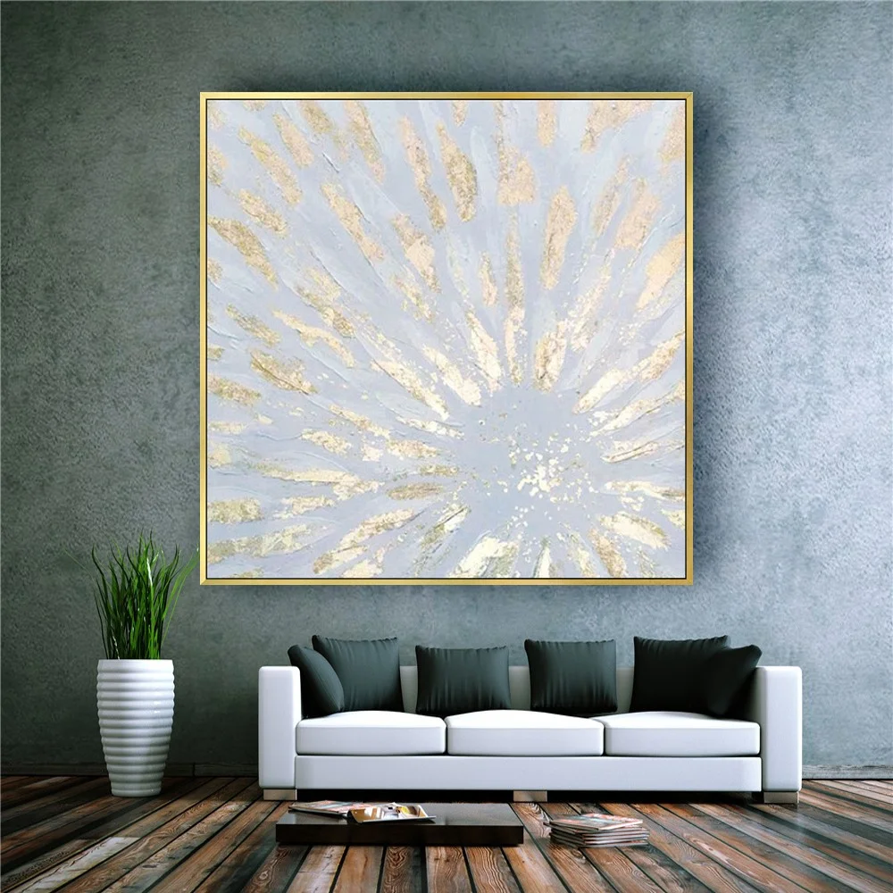 Room mockup showing pale grey square abstract painting with gold-coloured textured rays spreading from an off-centre point.