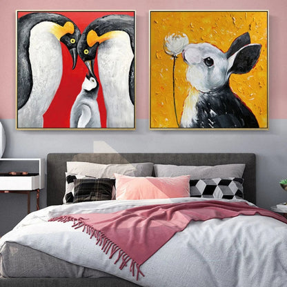 Room mockup showing pair of playful animal paintings: black-and-white penguins on red and a black-and-white cow on yellow.
