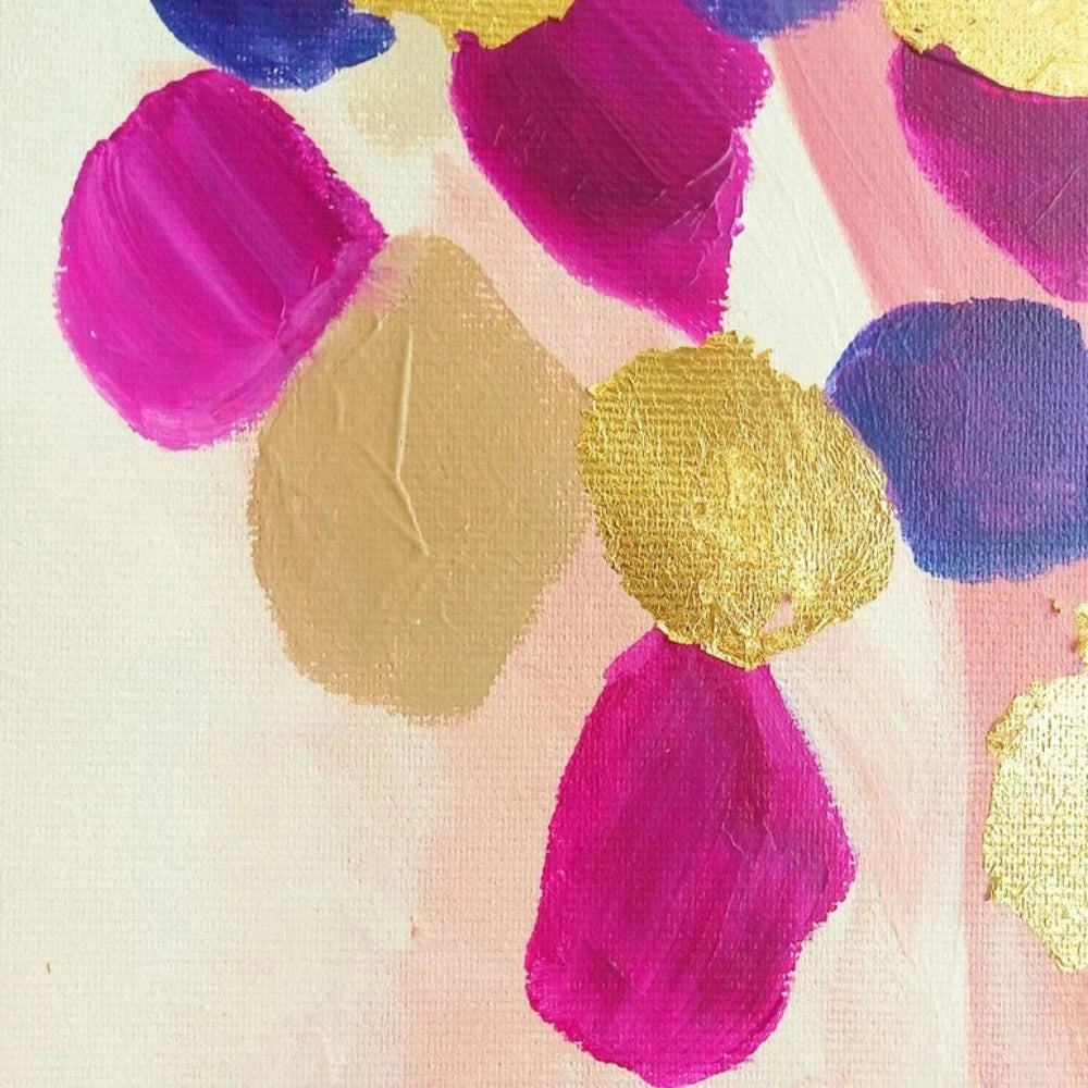 Close-up of rounded pink, magenta, purple and gold-coloured patches clustered over a pale blush background.
