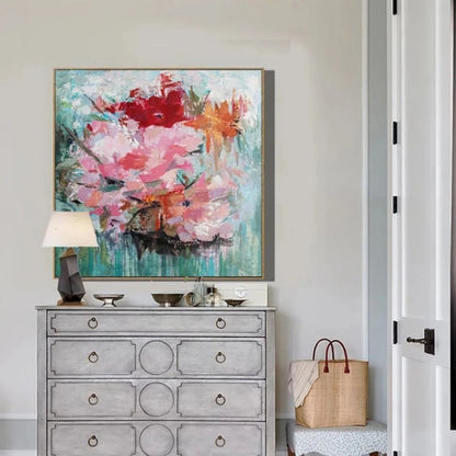 Room mockup showing large pink blossoms with red and orange flowers against a textured turquoise-green background.