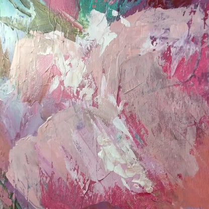 Close-up of layered pale pink and magenta petals with white and turquoise marks and visible raised texture.