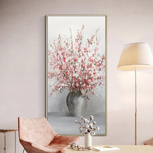 Room mockup showing tall spray of pink and white blossoms in a rounded grey vase against a pale grey background.
