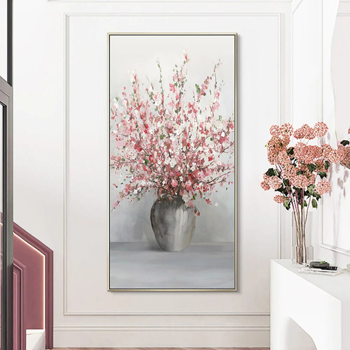 Room mockup showing tall spray of pink and white blossoms in a rounded grey vase against a pale grey background.