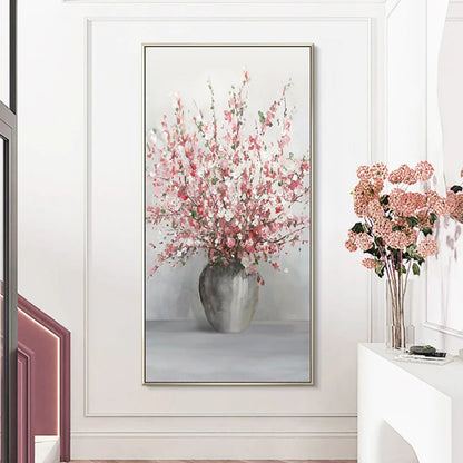 Room mockup showing tall spray of pink and white blossoms in a rounded grey vase against a pale grey background.