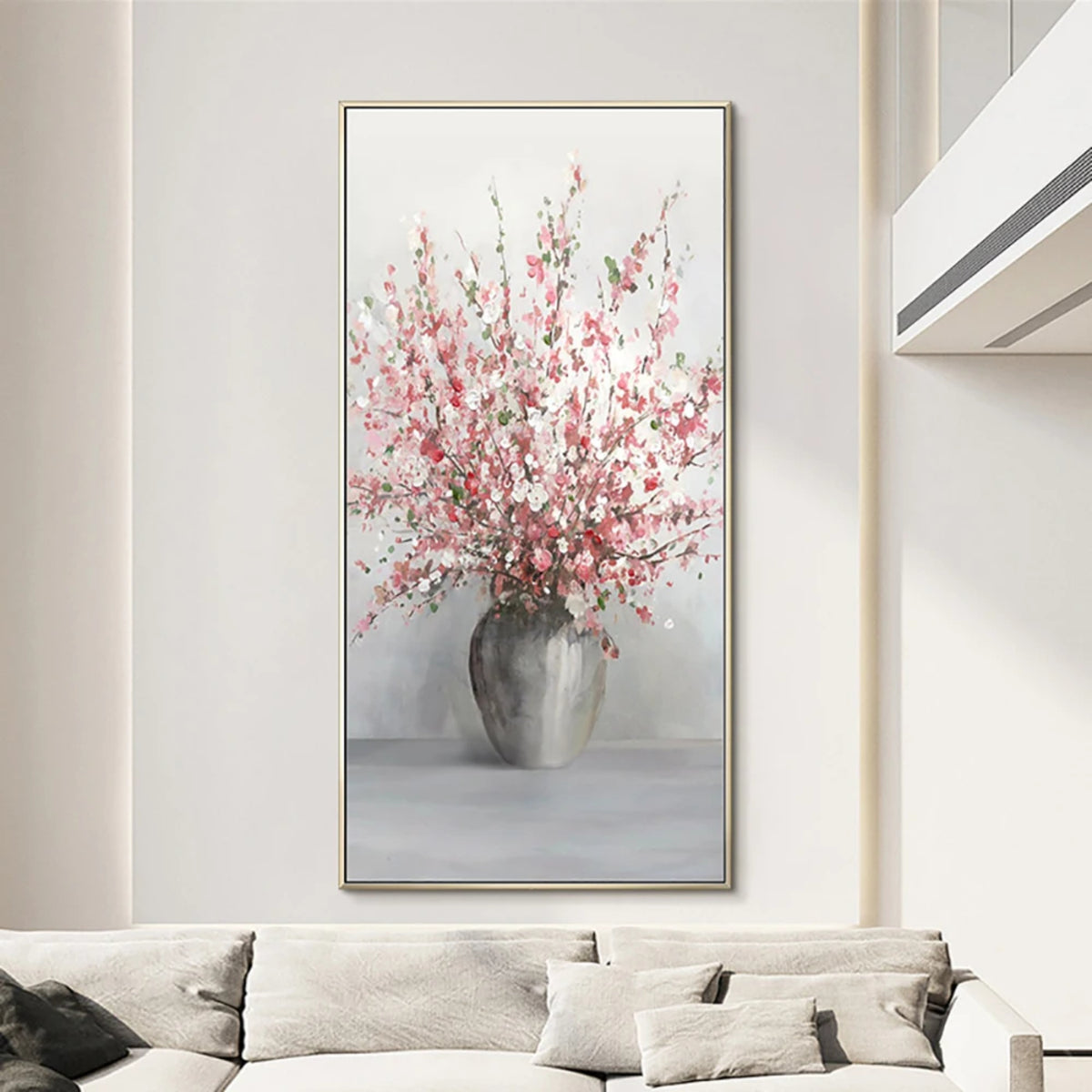 Room mockup showing tall spray of pink and white blossoms in a rounded grey vase against a pale grey background.