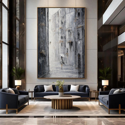 Modern living room with dark blue sofa, gray armchair, and abstract painting on wall.