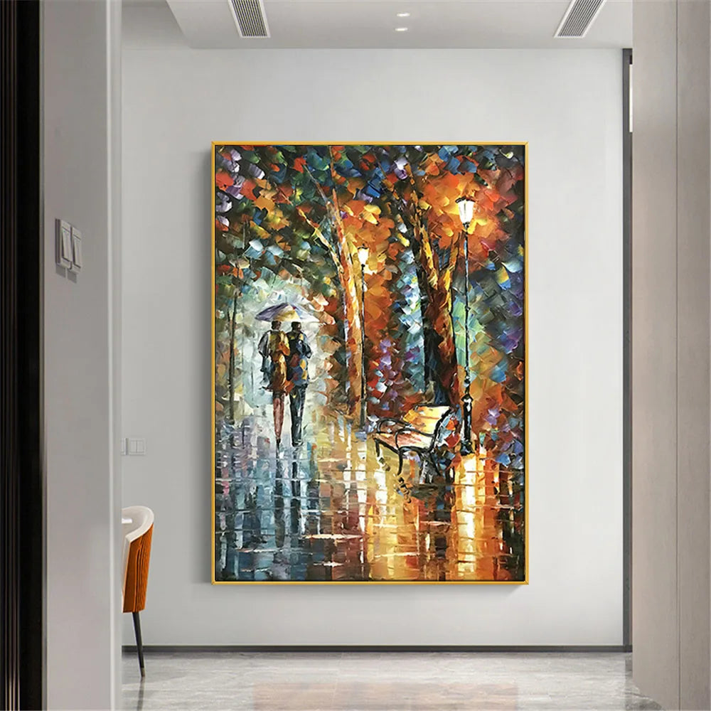 Room mockup showing couple beneath an umbrella on a rain-soaked park path, with orange lamps, dark trees and colourful reflected light.