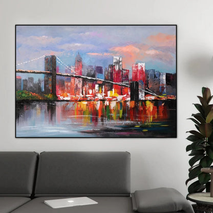 Room mockup showing red and blue city buildings behind a dark bridge, with warm red-orange reflections beneath a pale pink-blue sky.