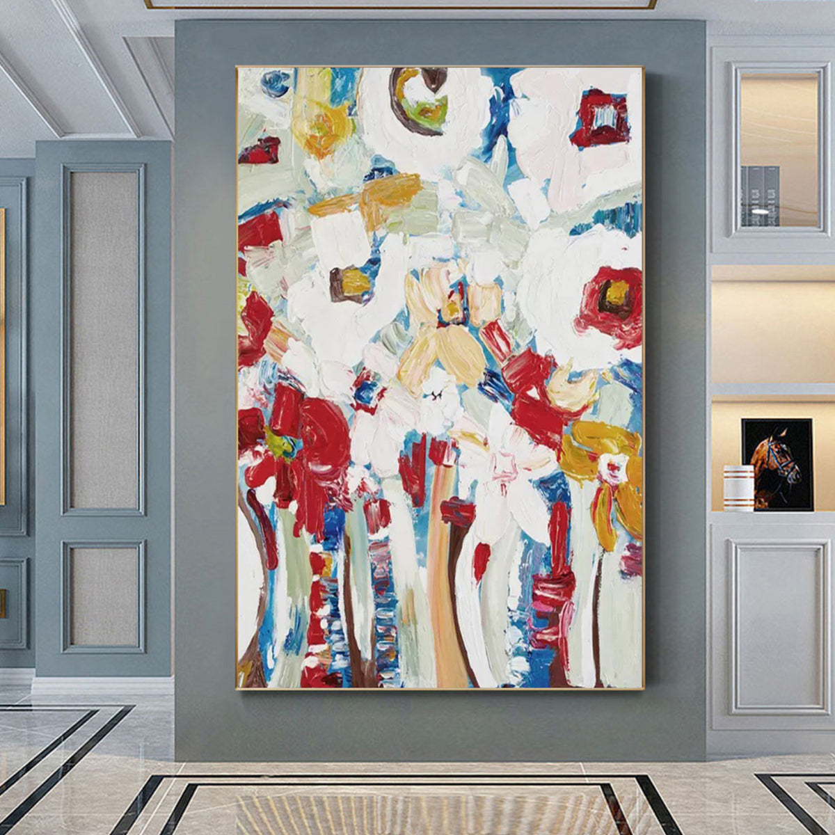 Room mockup. Loose red flower-like patches and blue and ochre stems rise through a heavily textured white background.