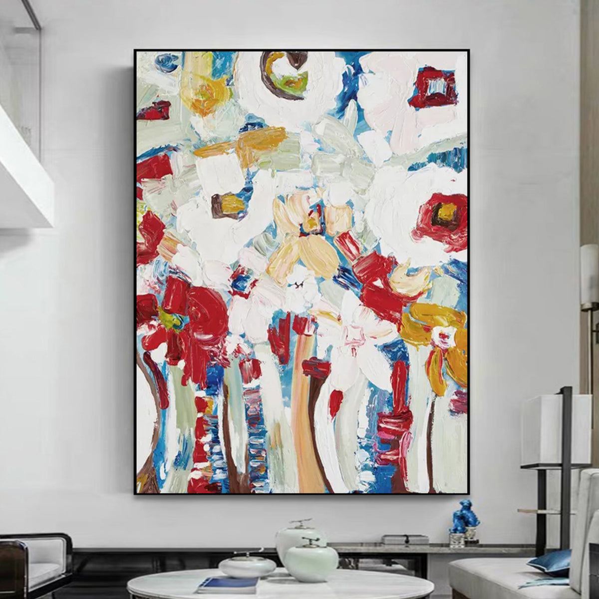 Room mockup. Loose red flower-like patches and blue and ochre stems rise through a heavily textured white background.