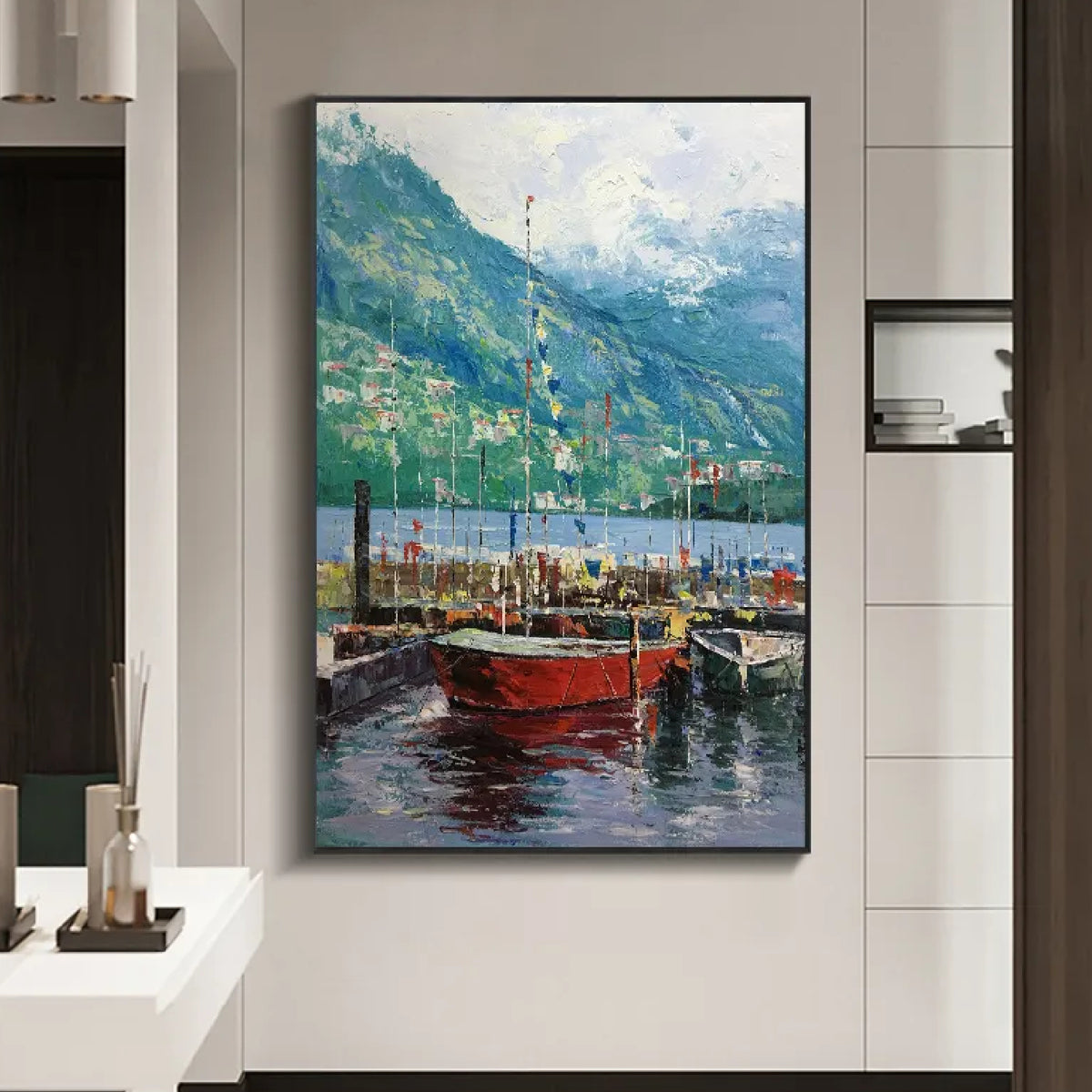 Room mockup. Red boats with fine masts float on dark blue water beneath green mountains and a pale clouded sky.