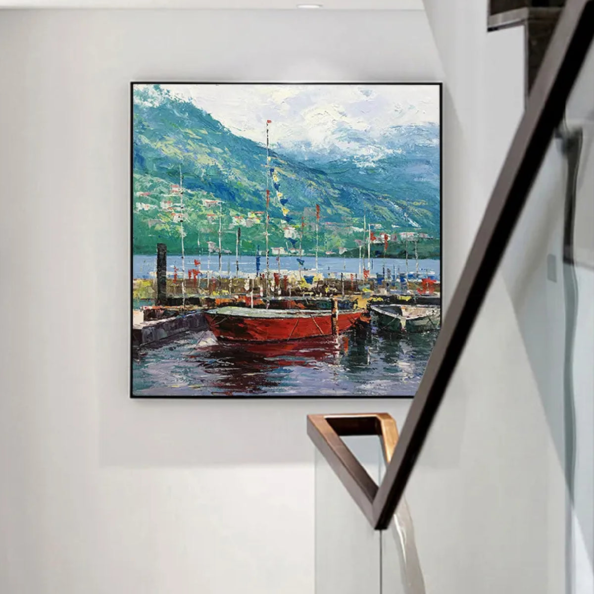 Room mockup. Red boats with fine masts float on dark blue water beneath green mountains and a pale clouded sky.