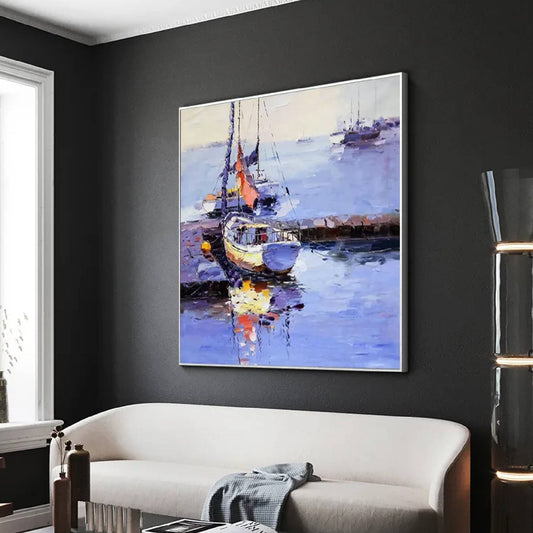 Room mockup. A small pale boat with a tall mast and orange sail beside a dark jetty, reflected in lavender-blue harbour water.