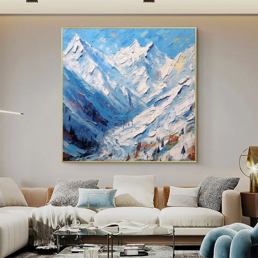 Room mockup showing jagged snow-covered mountains in blue and white above a deep blue valley with small dark trees and warm accents.